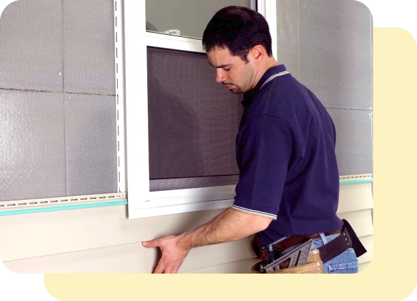 worker putting on window frame